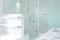 shower-next-to-marble-tub-marbel-floating-shelves-over-tub